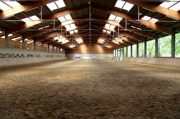 View in an indoor riding hall for horses and riders. The riding school is suitable for dressage and jumping  horses - Photo, Image