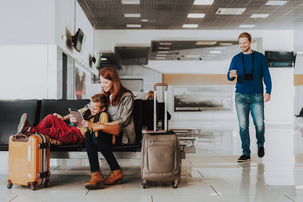 Happy family is wasting time before departure at airport - Фото, зображення