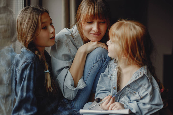 Mother with daughters at home - Foto, imagen