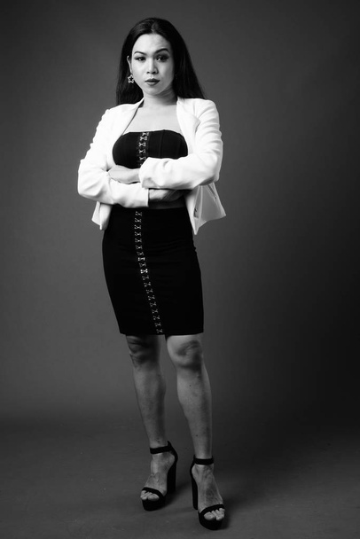 Full length portrait of transgender businesswoman in black and white - Фото, изображение