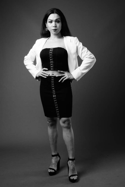 Full length portrait of transgender businesswoman in black and white - Photo, image