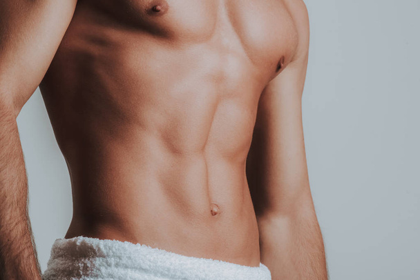 Close up of male body with white towel on the hips - Foto, Imagem