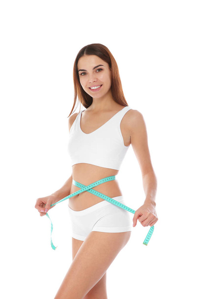 Slim woman measuring her waist on white background. Weight loss - Foto, imagen