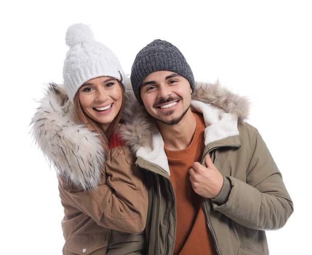 Young couple wearing warm clothes on white background. Ready for winter vacation - Foto, Imagem