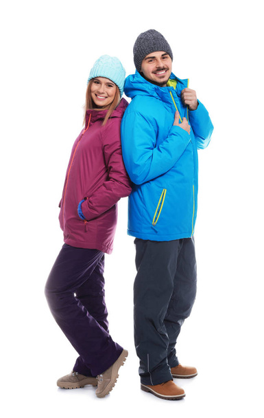 Young couple wearing warm clothes on white background. Ready for winter vacation - Φωτογραφία, εικόνα