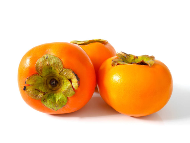 Group of fresh ripe persimmons isolated on white background - Photo, Image