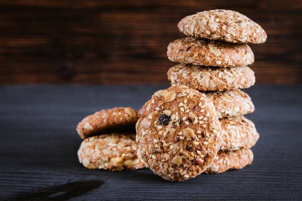 Oatmeal cookies laid pile on wooden background - Fotoğraf, Görsel
