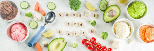 Trendy vegan food, summer healthy dessert concept, colorful diet vegetable ice cream with avocado, cucumber, tomato, beet, carrot, broccoli, cauliflower. Frozen veggie smoothie,  banner - 写真・画像