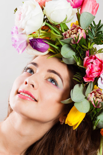 Spring Woman with flowers hairstyle and rainbow make up - Фото, изображение