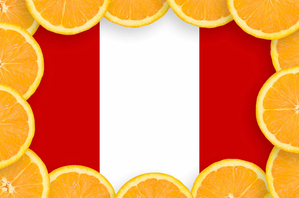 Peru flag  in frame of orange citrus fruit slices. Concept of growing as well as import and export of citrus fruits - Photo, Image