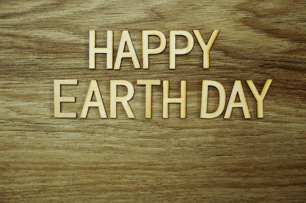Happy Earth Day text message on wooden background - Φωτογραφία, εικόνα