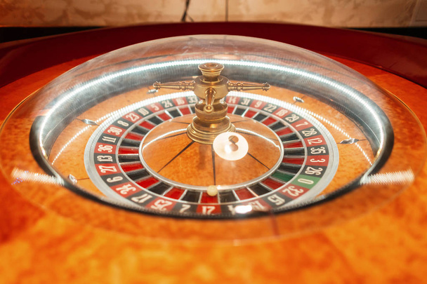Mesa de ruleta de madera dorada en casino. La ruleta se detuvo. Apostando por dinero. Primer plano
 - Foto, imagen