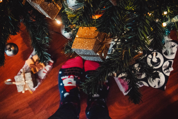クリスマスツリーや装飾の背景に女性の足 - 写真・画像