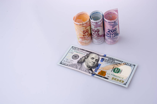 Amerikai dollár-bankjegyek és Turksh líra bankjegyeit egymás mellett a fehér háttér - Fotó, kép