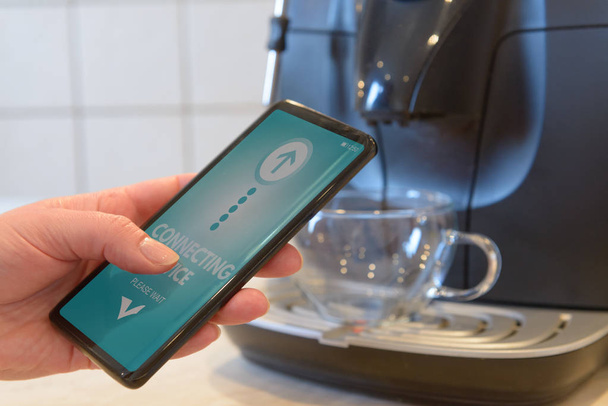 Conexión de cafetera con teléfono inteligente. Hogar inteligente e Internet de las Cosas Concepto IoT
 - Foto, Imagen