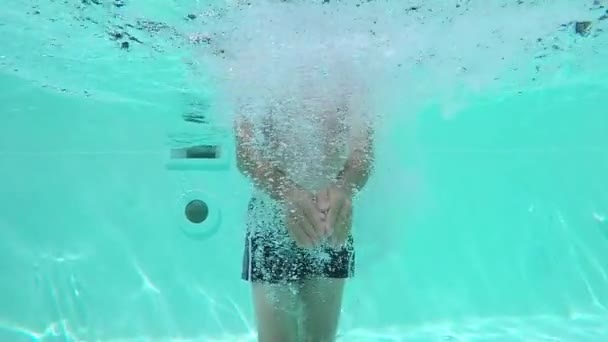 Man creating water displacement in the pool by moving the hands upwards and downwards. - Footage, Video