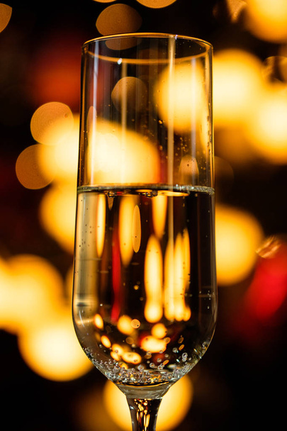 Glasses of champagne on the background of lights with roses and red ribbon - Fotoğraf, Görsel