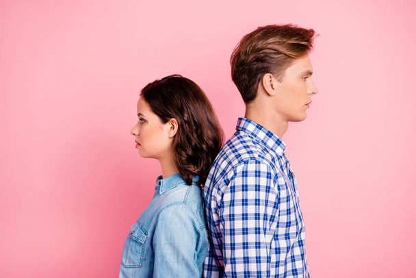 Close up portrait of two she her he him his after fight boy lady looking indifferent to empty space wearing casual shirts denim plaid outfit isolated on rose background - Valokuva, kuva