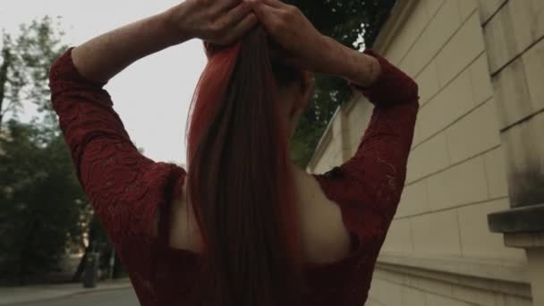 zadní pohled na rudě ženskou upíra na ulici - Záběry, video
