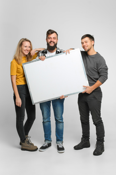 Young people holding white board - Foto, immagini