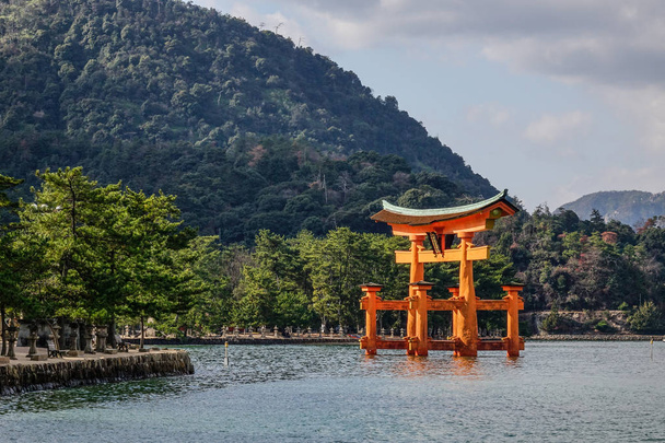 View of floating gate (Giant Torii) of Itsukushima Shrine on sea in Hiroshima, Japan. The temple is a UNESCO World Heritage Site. - Photo, Image