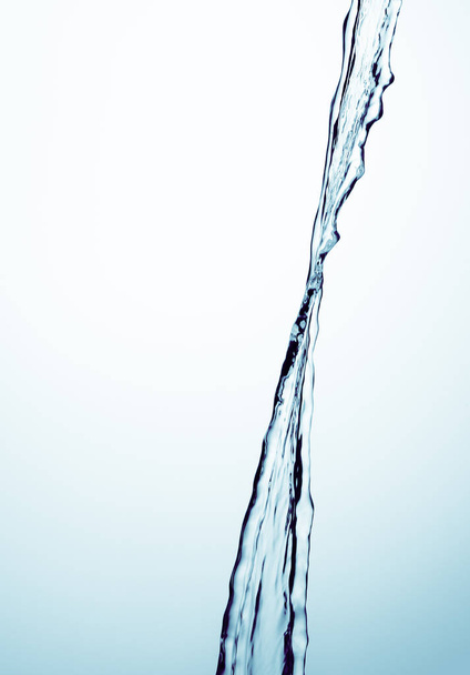 A jet of water on a blue background - Фото, изображение