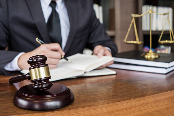Legal law, advice and justice concept, Judge gavel with Justice lawyers, Counselor in suit or lawyer working on a documents in courtroom. - 写真・画像