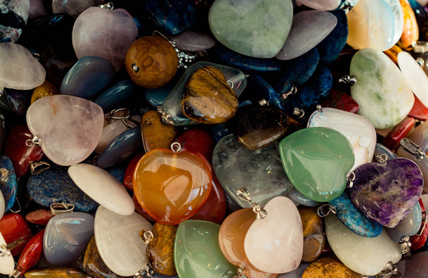 Heart shaped semi precious stones in view as a background - Photo, Image