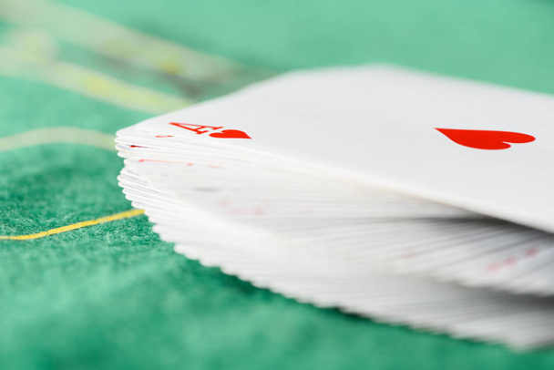 selective focus of unfolded playing cards in deck on green poker table - Photo, Image