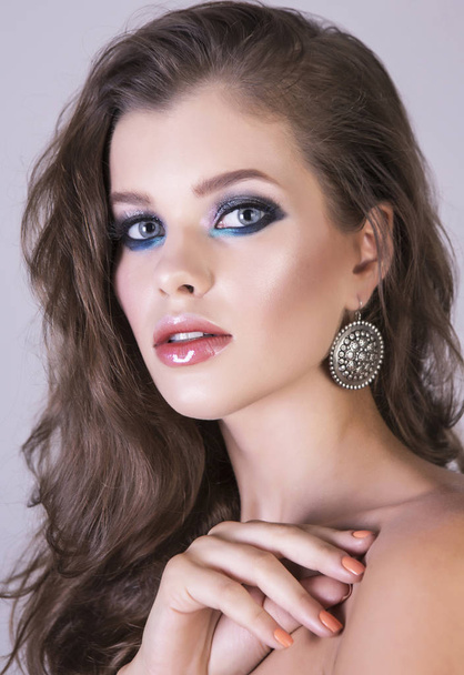Sexy looking young brunette woman with interesting makeup and accessories. Vertical studio shot. - Foto, imagen