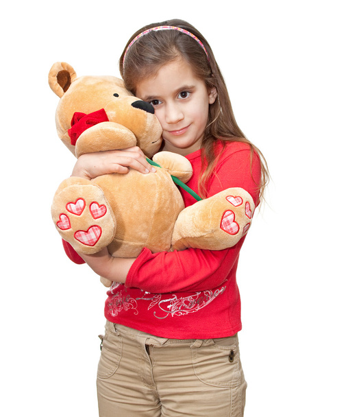 Small girl hugging a teddy bear - Фото, изображение