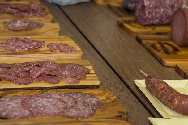 Various Types of Italian Sliced Salami on Wooden Chopping Boards. - Photo, Image