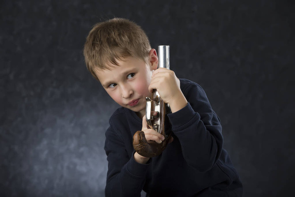 Boy with a gun. The child plays with the weapon. Six seven year old toddler with retro boob - Zdjęcie, obraz