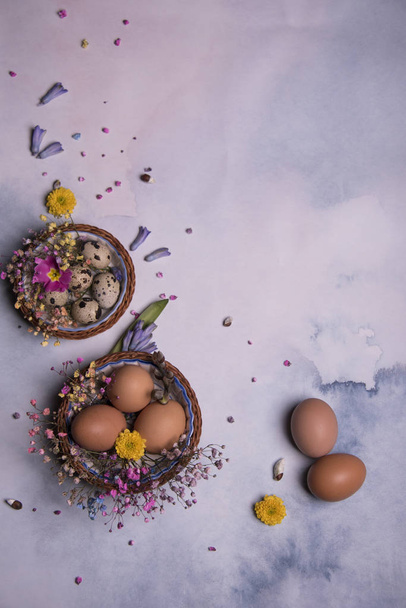 Happy Easter card template with eggs in baskets and fresh flowers  - Photo, Image