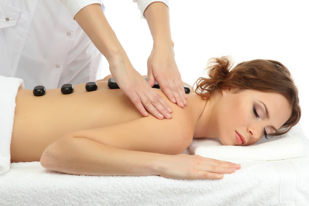 beautiful young woman in spa salon getting massage with spa stones - Foto, immagini