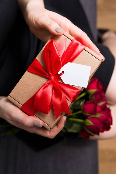 Romantic gift surprise closeup - Valentines day present, brithday, anniversary, romantic relationship gift tag - Фото, изображение