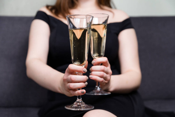 Romantic date, champagne glasses, beautiful woman holding two champagne glasses. - Photo, Image