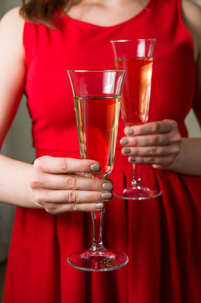 Romantic date, champagne glasses, beautiful woman holding two champagne glasses. - Photo, Image