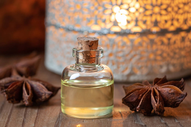 A bottle of essential oil with star anise - Photo, Image