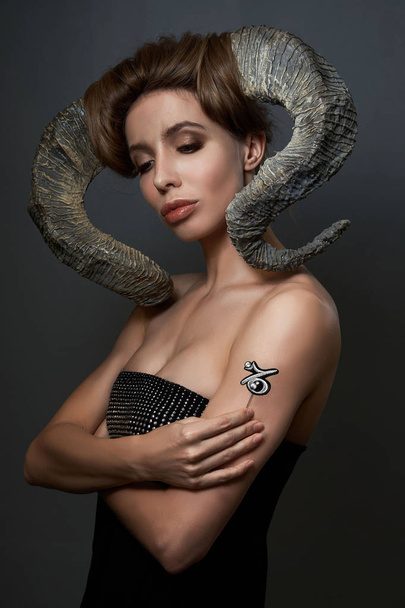 girl in the image of the zodiac sign Capricorn with horns - Photo, image