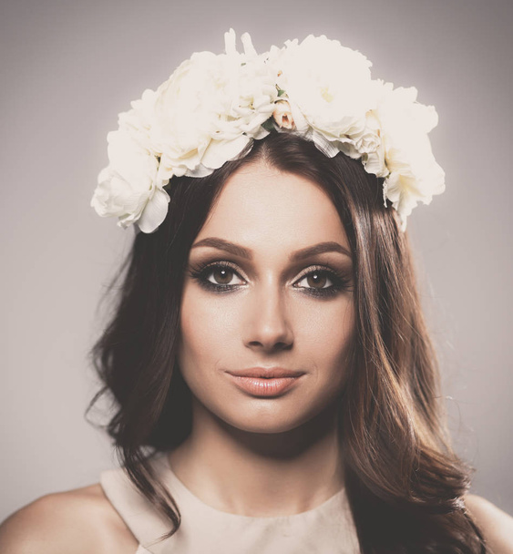 Portrait of a beautiful woman with flowers in her hair - Zdjęcie, obraz