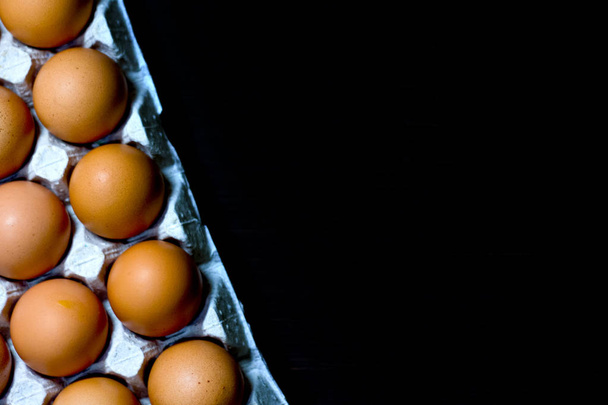 Eggs egg carton box copyspace food box dark wooden board top view top. - Photo, Image