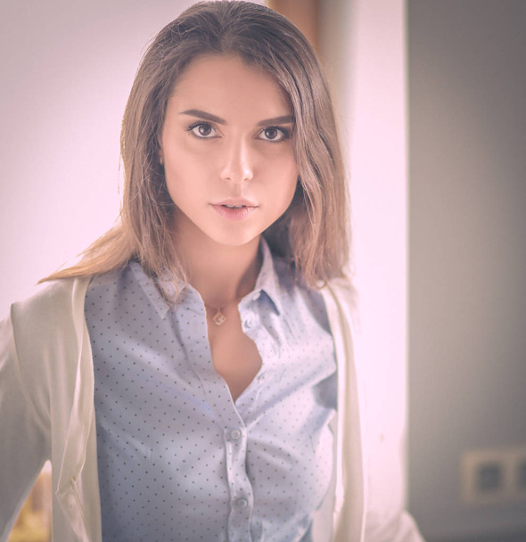 Young woman is standing near window. Business Woman. - Photo, Image