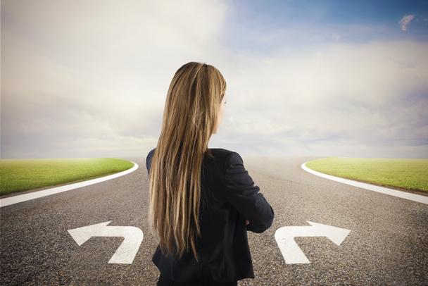 Businesswoman at a crossroads. She chooses the correct way. Concept of decision in business - Photo, Image
