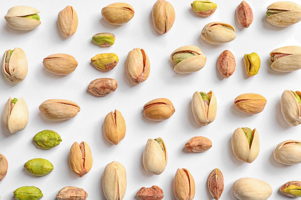Composition with organic pistachio nuts on white background, top view - Φωτογραφία, εικόνα