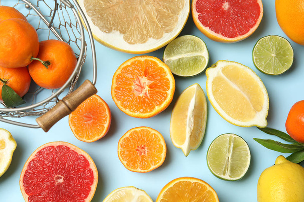 Different citrus fruits on color background, top view - Photo, Image