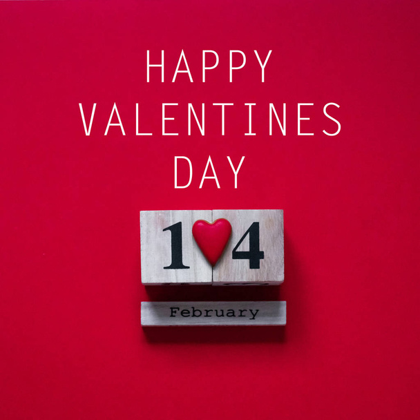 14 February. Red background with wooden calendar. Valentine's day concept. Valentines day card concept.  - Photo, Image