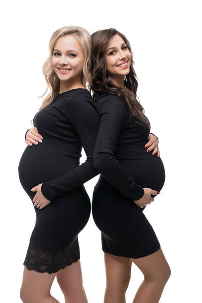Happy preganant blonde and brunette isolated view - 写真・画像