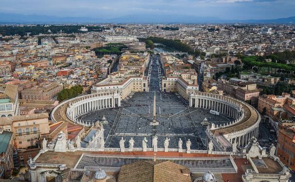 Looking down panorama view over Saint Peter Square (Piazza San Pietro) and Rome City, from St. Peter Basilica dome. - Fotó, kép