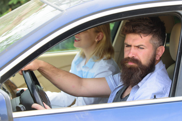 Ecology and environment. Bearded man and sexy woman driving car. Loving couple enjoy sustainable travel. Couple in love travel by automobile transport. Using sustainable transport for zero pollution - Photo, Image